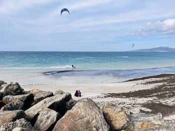 Scenic view of rocks on beach against sky