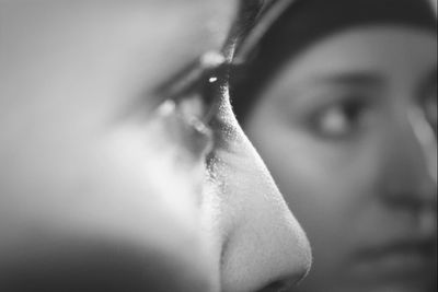 Close-up of two young woman staring into distance