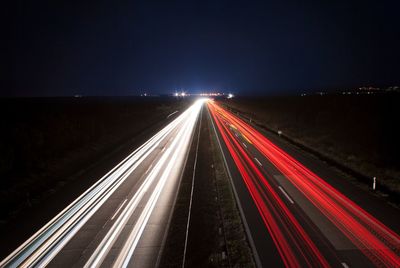 High angle view of light trails on highway at night