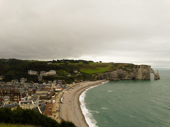 High angle view of townscape by sea against sky