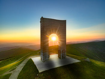 Scenic view of landscape against clear sky during sunset