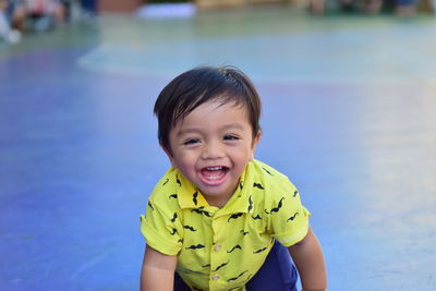 Portrait of cute smiling boy in swimming pool