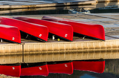 Red deck chairs by river