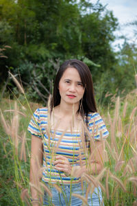 Portrait of teenage girl smiling on field