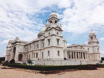 Low angle view of a building against cloudy sky