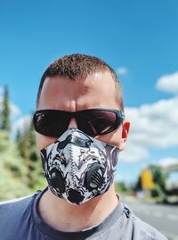 Portrait of man wearing sunglasses and mask against covid-x