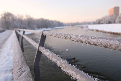 Close-up of frozen river against sky during winter