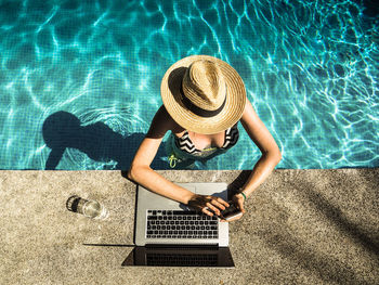 High angle view of woman using mobile phone at swimming pool