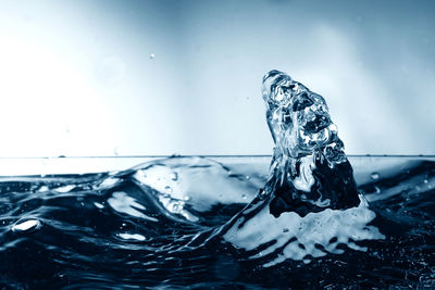 Close-up of splashing water against sky