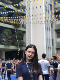 Portrait of young woman standing outdoors