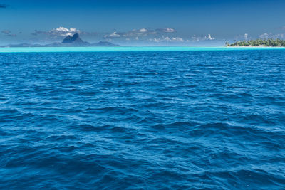 Scenic view of sea against blue sky