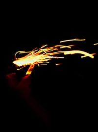 Close-up of illuminated light over black background