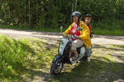 Side view of man riding motorcycle on field