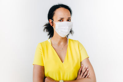 Portrait of beautiful young woman against white background