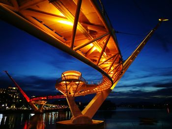 Low angle view of illuminated bridge against sky at night