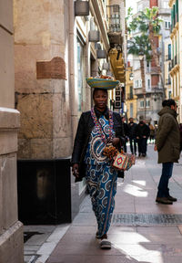 Full length of woman walking on street in city