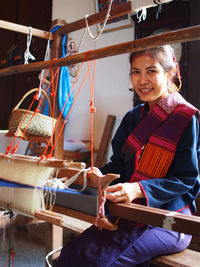 Woman weaving wool in workshop