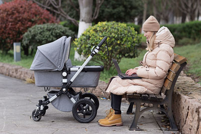 Low section of woman sitting on street