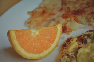 Close-up of orange slice in plate