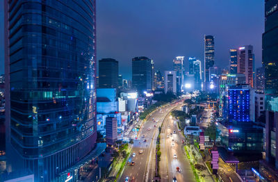 Traffic on city street and buildings at night