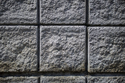 Close up of light gray squares that compose a weather-proof wall