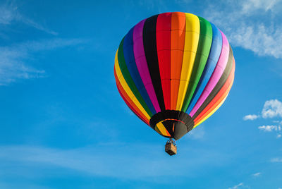 Low angle view of hot air balloon against blue sky