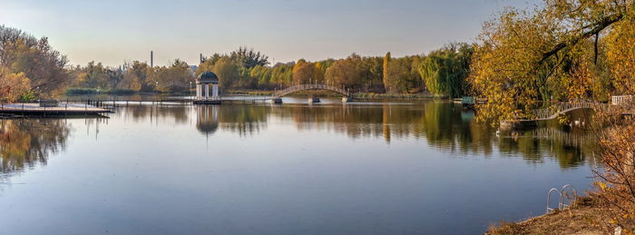 Sunny autumn evening on the blue lake with yellow trees. the ivanki village in cherkasy region