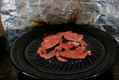 High angle view of meat on barbecue grill