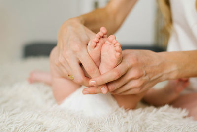 Mother holds newborn baby tiny feet. happy motherhood