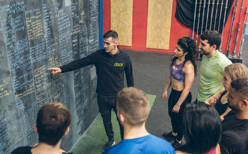 Coach explaining to a group of athletes in the gym