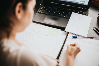 Midsection of woman working at desk