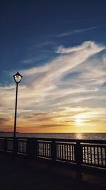 Silhouette pier by sea against sky during sunset