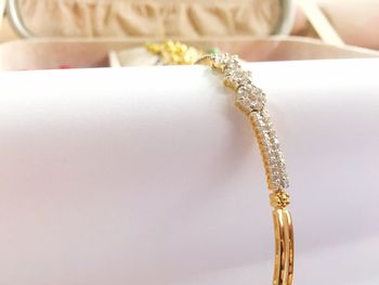 Close-up of bracelet on white container