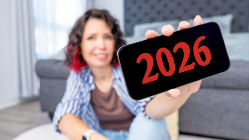 Midsection of woman using digital tablet