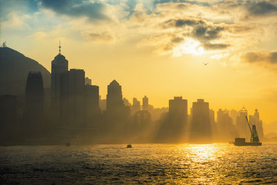 Scenic view of cityscape against sky during sunset