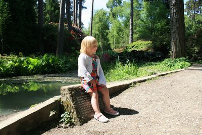 Full length of girl on plants against trees