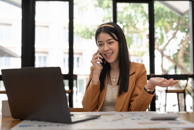 Businesswoman using laptop at office