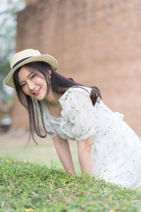 Portrait of young woman wearing hat