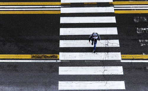 High angle view of man crossing road