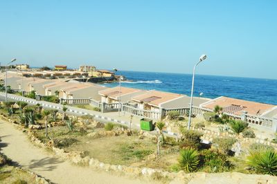 Scenic view of beach against clear blue sky