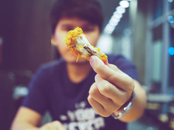 Close-up of hand holding meat