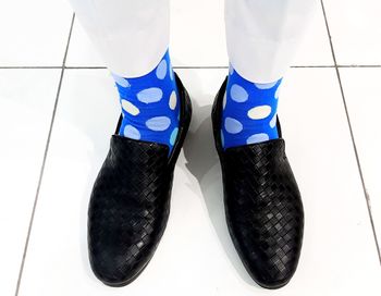 Low section of man wearing shoes