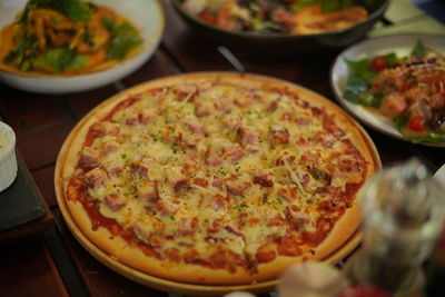 High angle view of pizza served on table