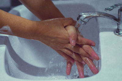 Midsection of woman in bathroom at home