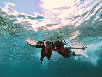 People swimming in sea