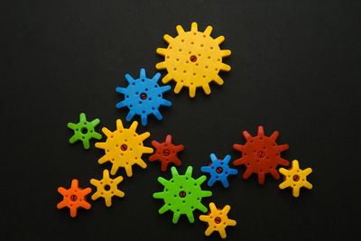 Multi colored toy machinery on black background