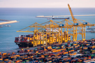 Commercial dock by sea against sky