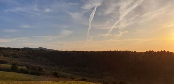Scenic view of field against sky during sunset