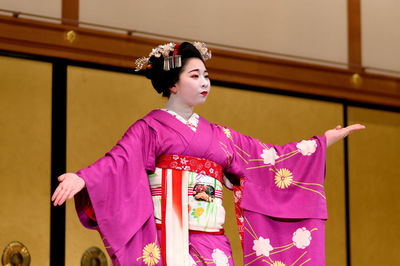 Low angle view of young woman indoors