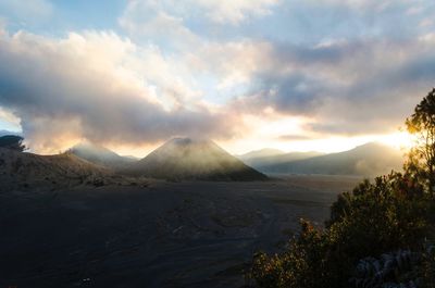 Scenic view of landscape against cloudy sky